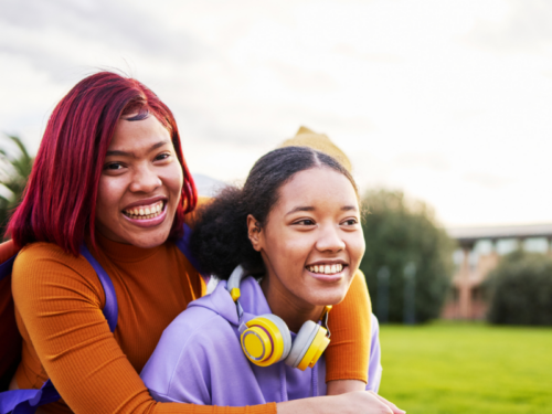 Two female teenage friends hugging each other. They have set healthy boundaries to strengthen their friendship.