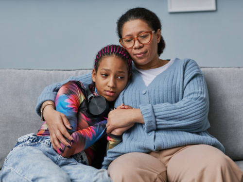 Mother comforting teen who is struggling with depression