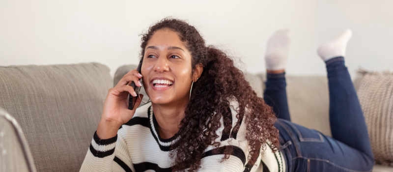 A young woman who is neurodivergent is on a phone call.