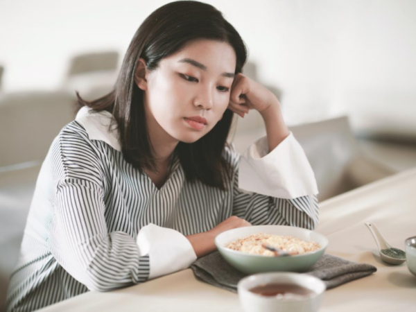 A woman struggling with dissociation stares into space.