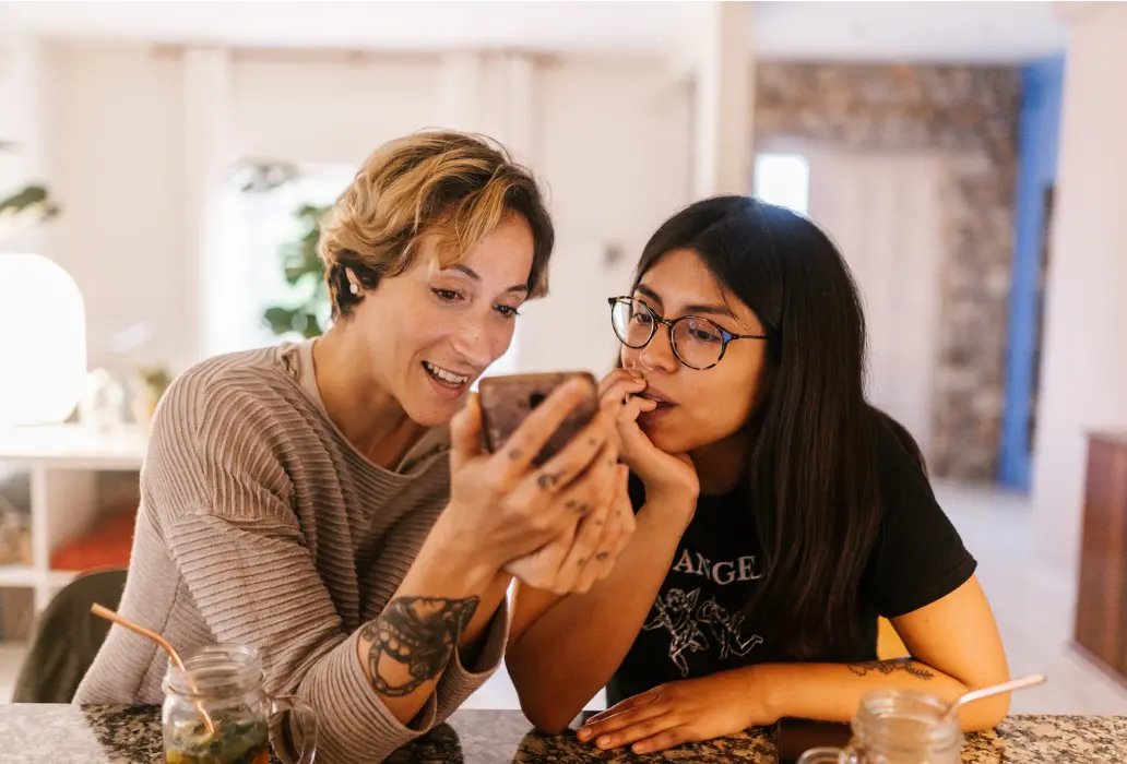 two women looking at a phone