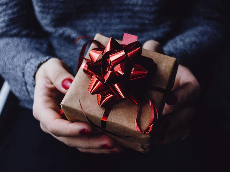 Person carrying a present to give to loved one