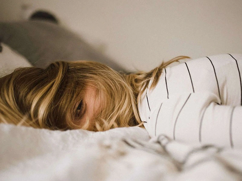 Teen laying in bed feeling stressed