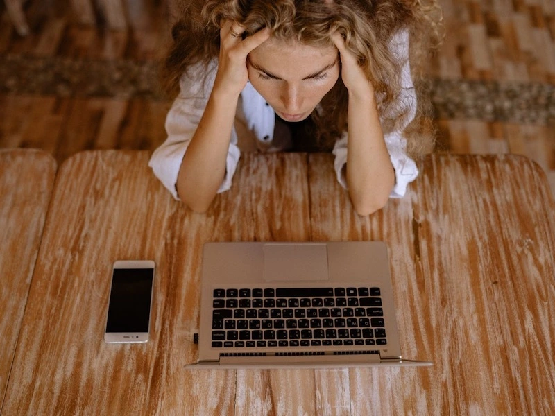 teen anxiously looking at her computer