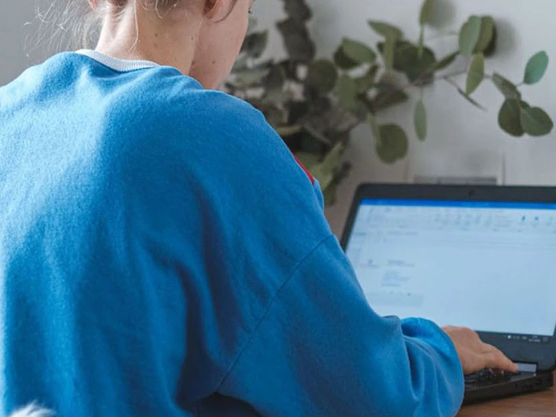 girl with anxiety working on her computer