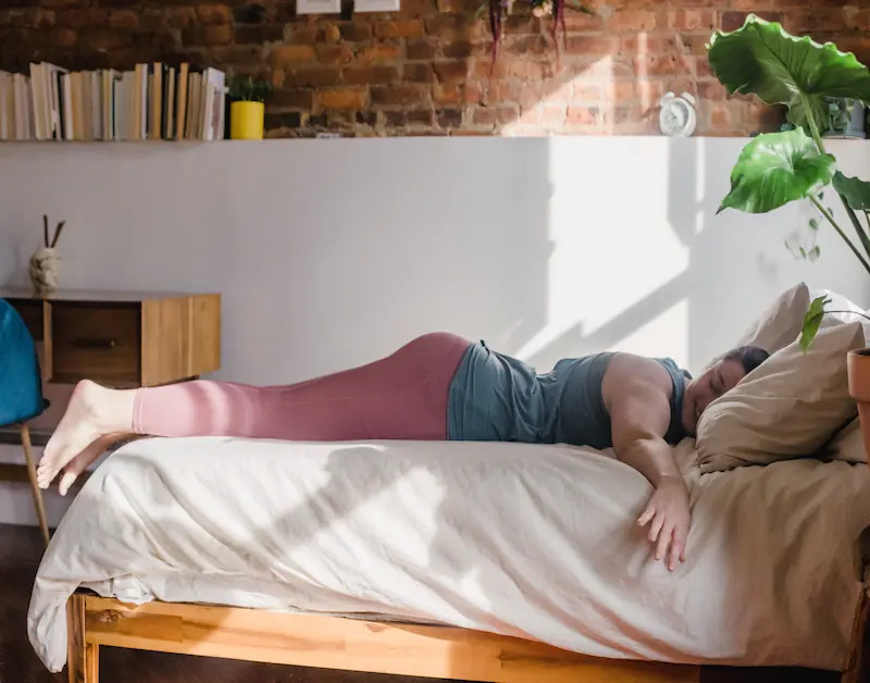 Teen asleep on their bed