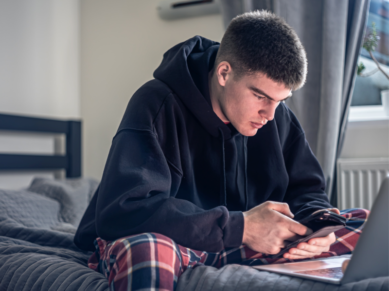 Teenager looking at his phone