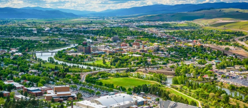 city with a lot of trees and hills surrounding it in Montana