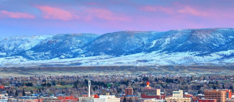 city in Wyoming with snow covered mountains in the background
