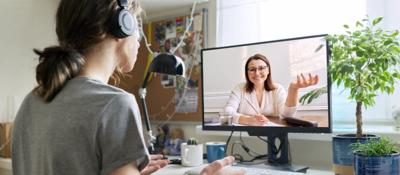 A trauma therapist meets with a teen virtually to do therapy