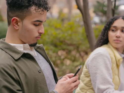 Two friends sit together with one of them trauma dumping about their traumatic experiences