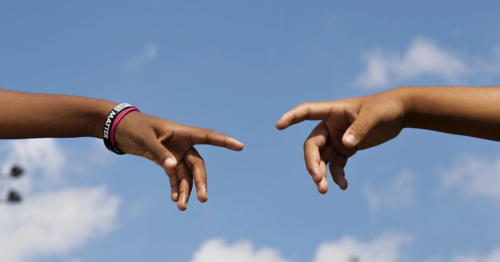 Two individuals reaching out to connect with each other