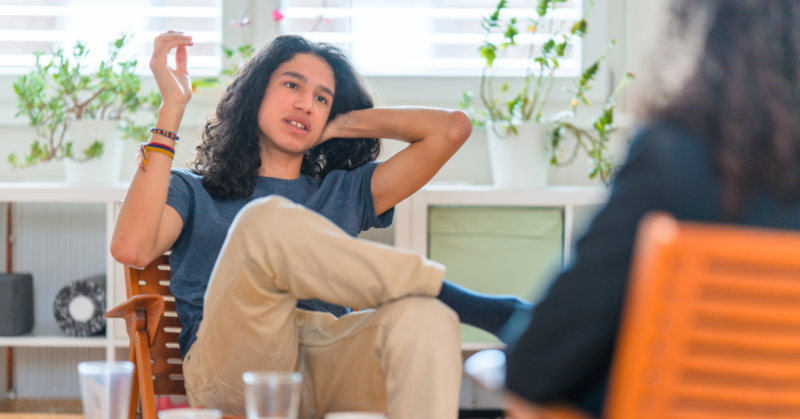 A young man struggling with substance abuse receives harm reduction resources with a counselor.