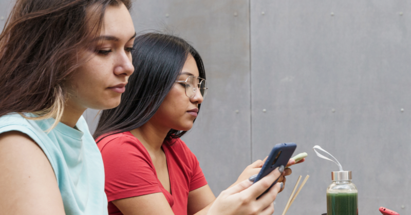 Two teens spending excessive time on their phones