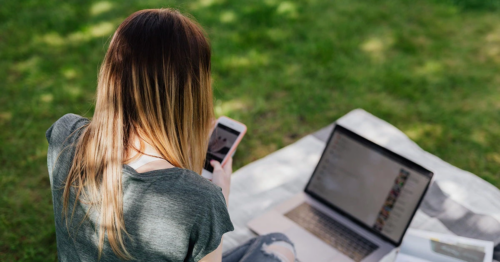 A teenage girl works on multiple devices to make a school project perfect