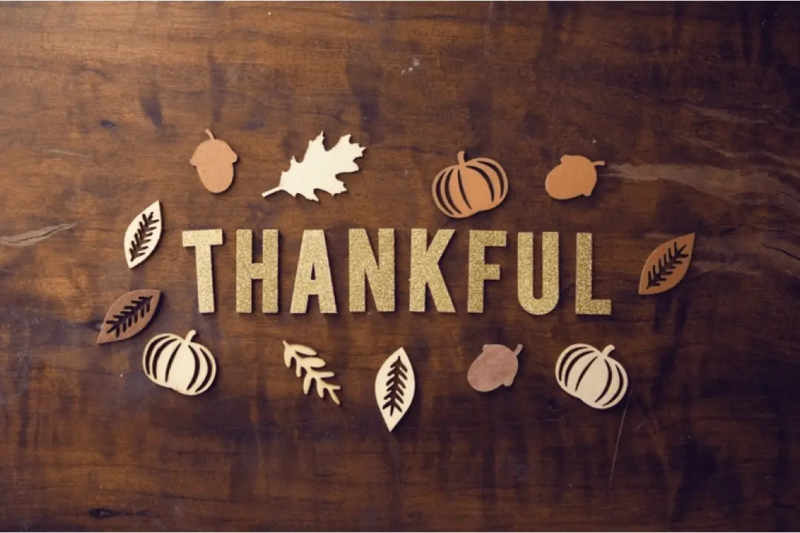 Letters spell out the word THANKFUL on a Thanksgiving table