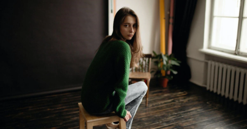 young woman with autism sitting in a room alone