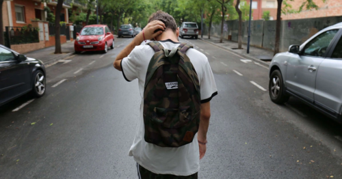 adolescent struggling with his mental health walking in the street