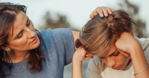 A parent comforts an anxious teen