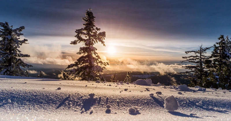 Calm sunny day on top of a snow covered mountain