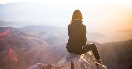 Young woman looking over a valley