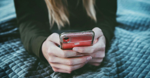 Teenager looking at social media on their phone