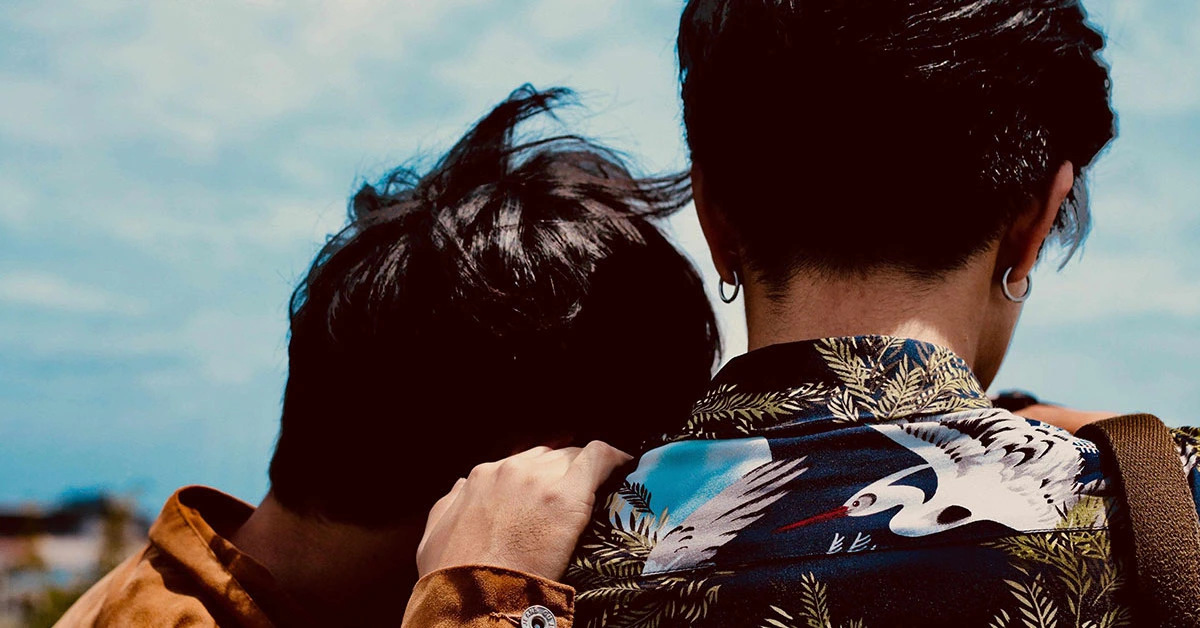 LGBTQIA+ teen couple lean on each other