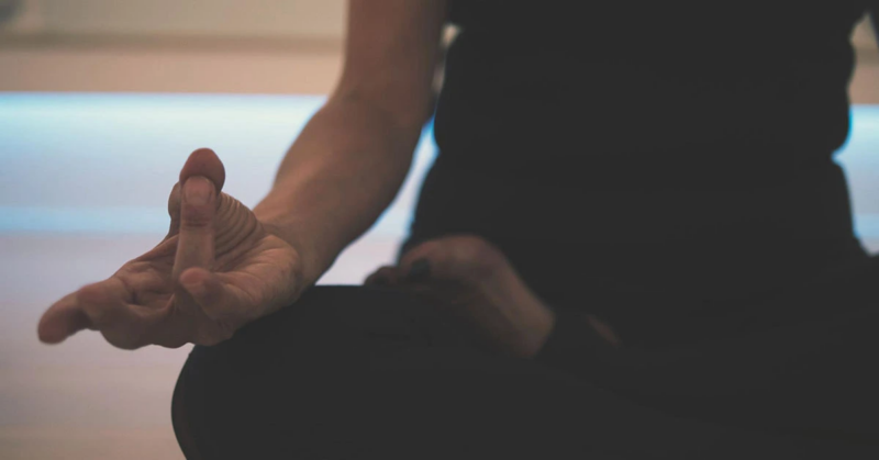 Person practicing yoga for mental health benefits