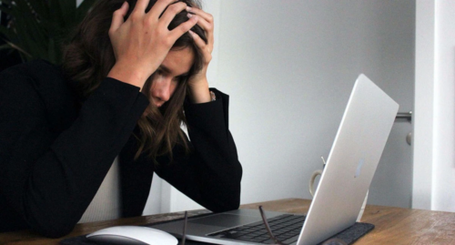 Young teen stressed out looking at her computer