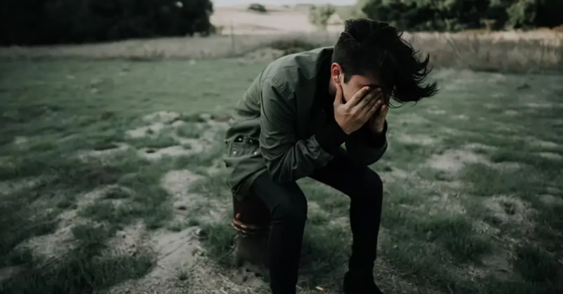 Teenager sitting alone feeling depressed