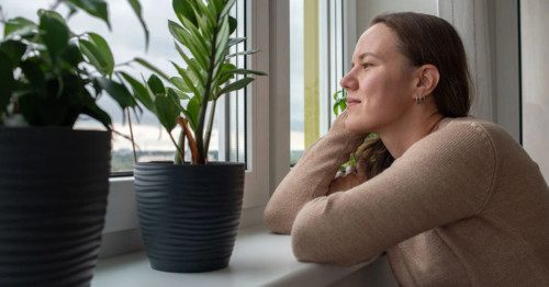 Woman staring out the window to help with stress