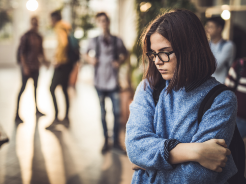 A person looks downward pensively