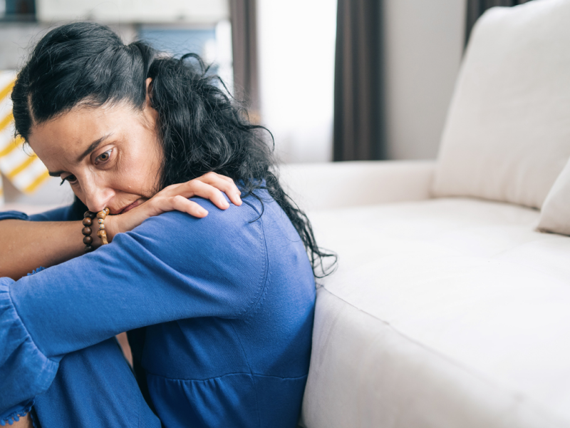 A woman with agoraphobia sits in her home