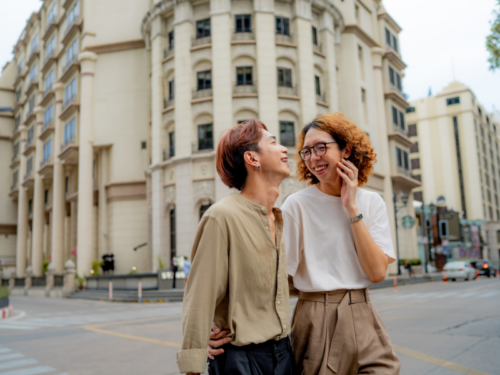 An individual with schizoid personality disorder walks and laughs with a friend