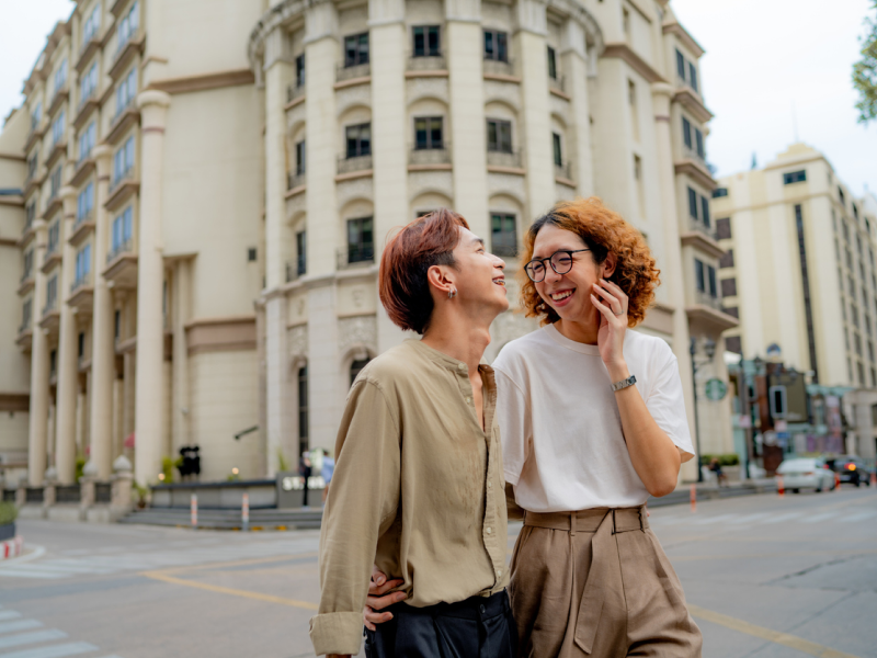 An individual with schizoid personality disorder walks and laughs with a friend