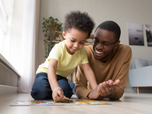 Father and son completing a puzzle together