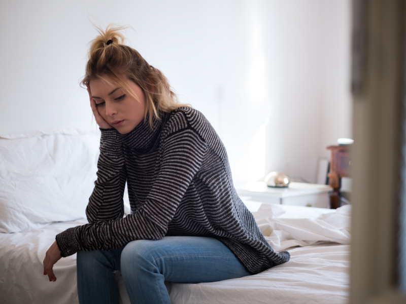 Teenage girl on her bed suffering from depression