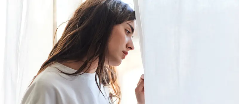 Girl looking out the window experiencing a depressive epiode