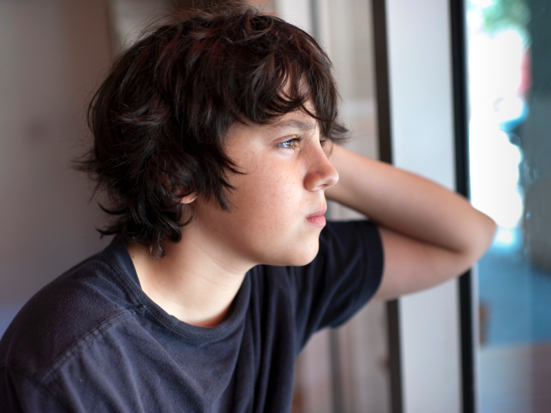Teen with anxiety staring out the window