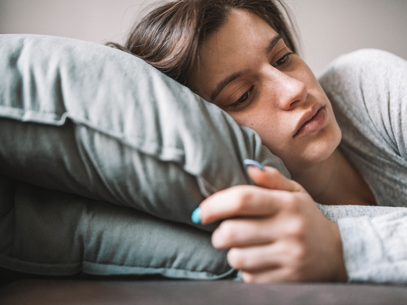 Teen laying down on a pillow dealing with borderline personality disorder