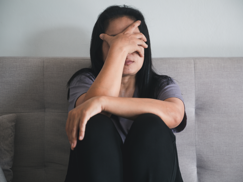 Teen girl dealing with trauma with her hand on her head