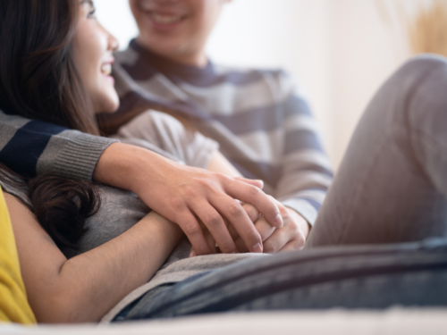 Couple cuddling and holding hands