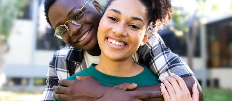 Couple hugging each other and smiling