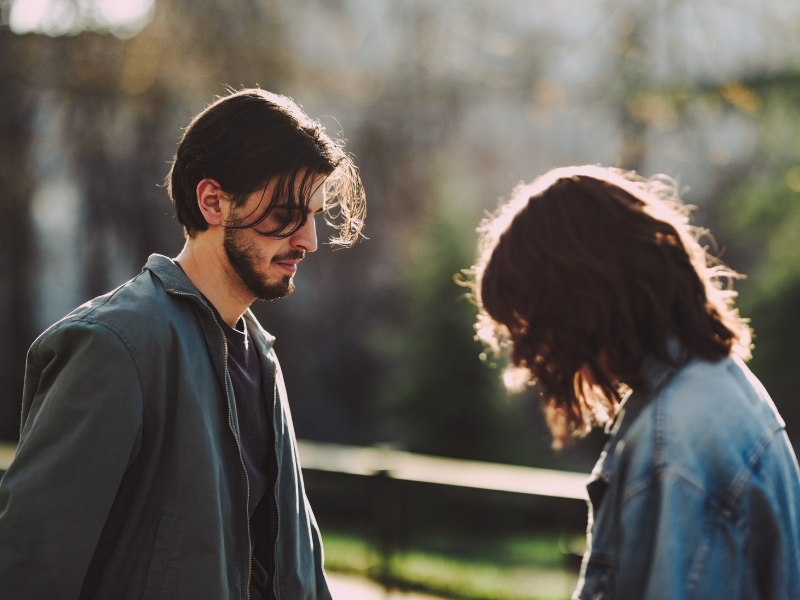 Couple talking to each other looking sad