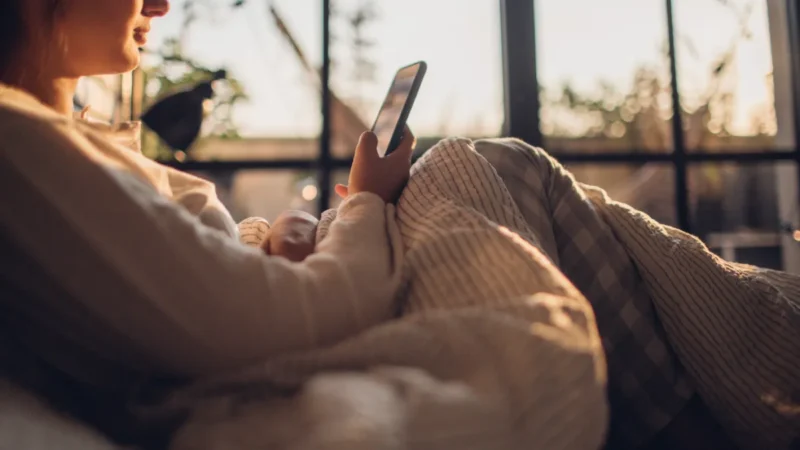 Girl on phone in bed