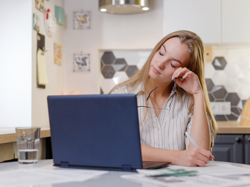 Young woman with blonde hair sits at her computer during a virtual IOP therapy session 