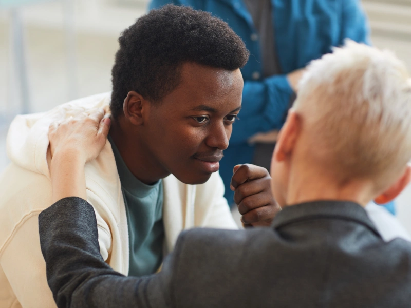 Therapist comforting teen in therapy