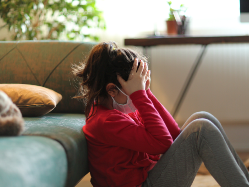 Teen with anxiety with her hands on her head