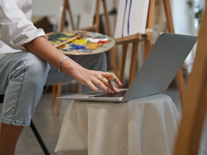 Person painting on laptop