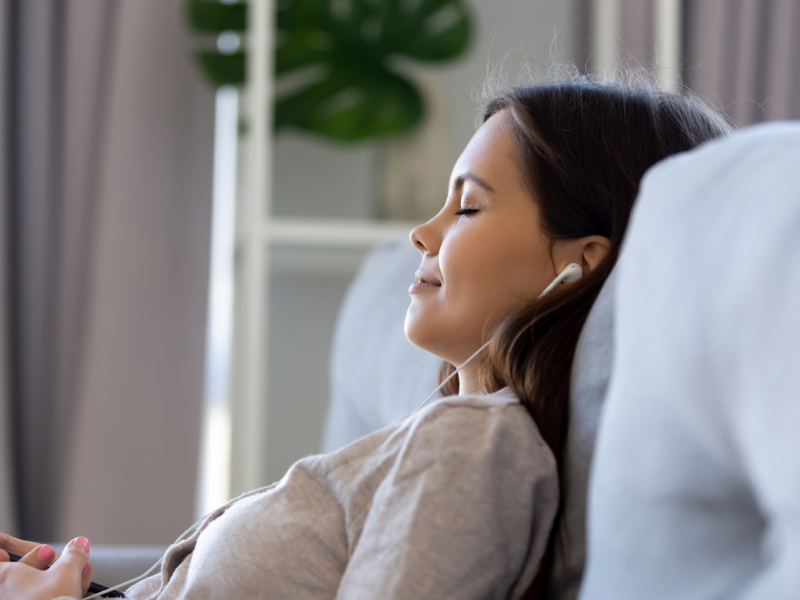 woman meditating with headphones